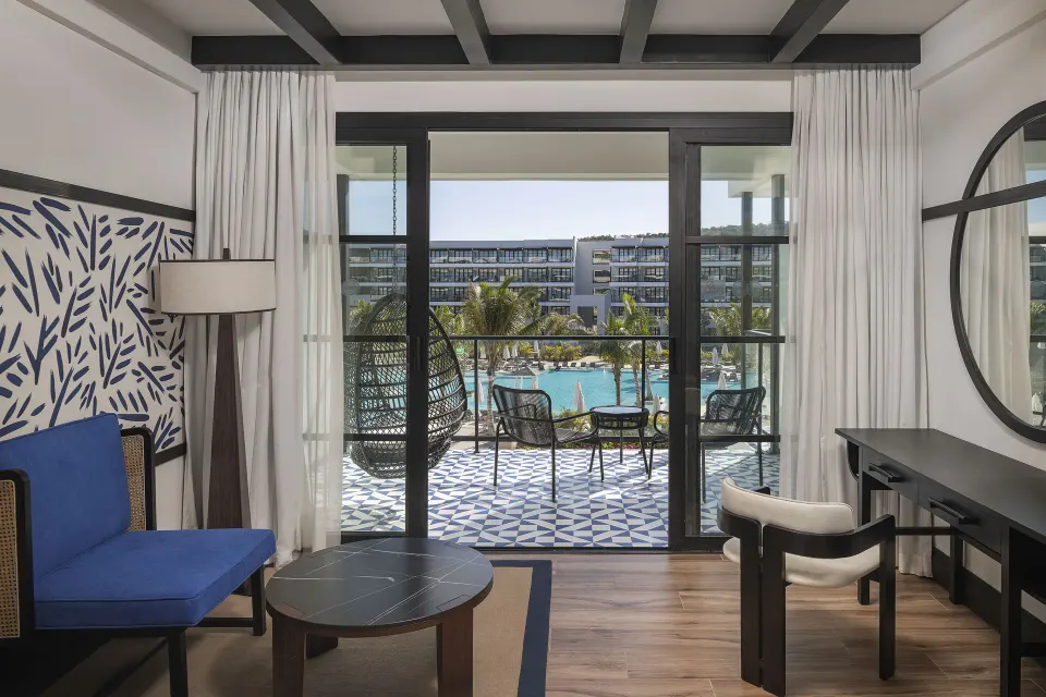 Junior Suite Nature View seating area and balcony doors at Ocean Eden Bay.
