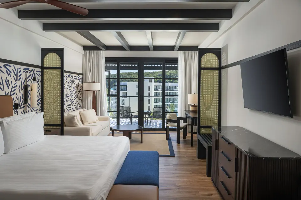 Junior Suite Nature View with king bed and balcony beyond at Ocean Eden Bay.