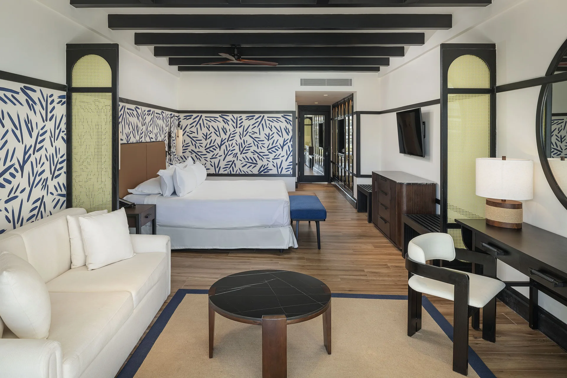 Junior Suite Nature View with king bed, sofa, desk and TV at Ocean Eden Bay.