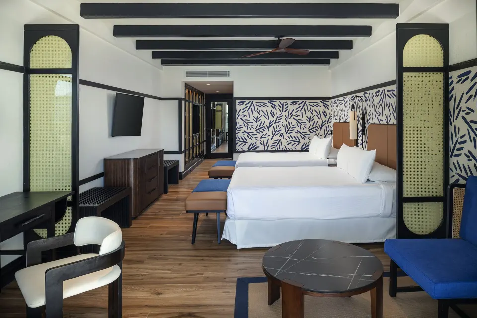 Junior Suite Nature View with two beds and seating area at Ocean Eden Bay.