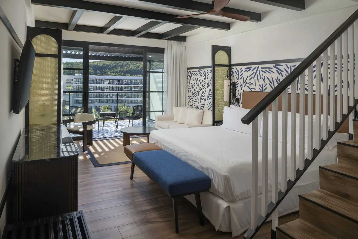 Privilege Junior Suite Rooftop bedroom with balcony view at Ocean Eden Bay.
