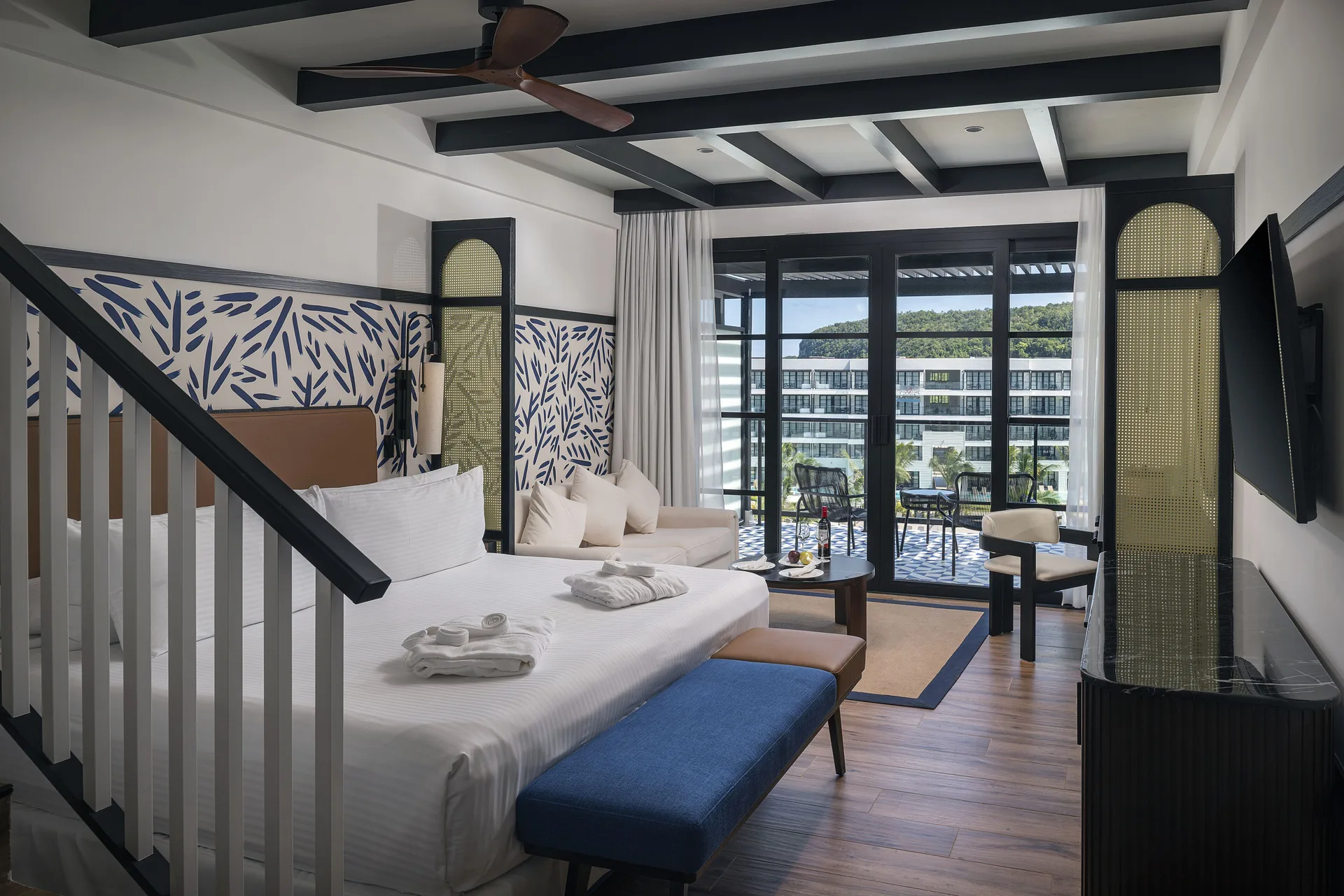 Privilege Junior Suite Rooftop king bed and lounge area at Ocean Eden Bay.