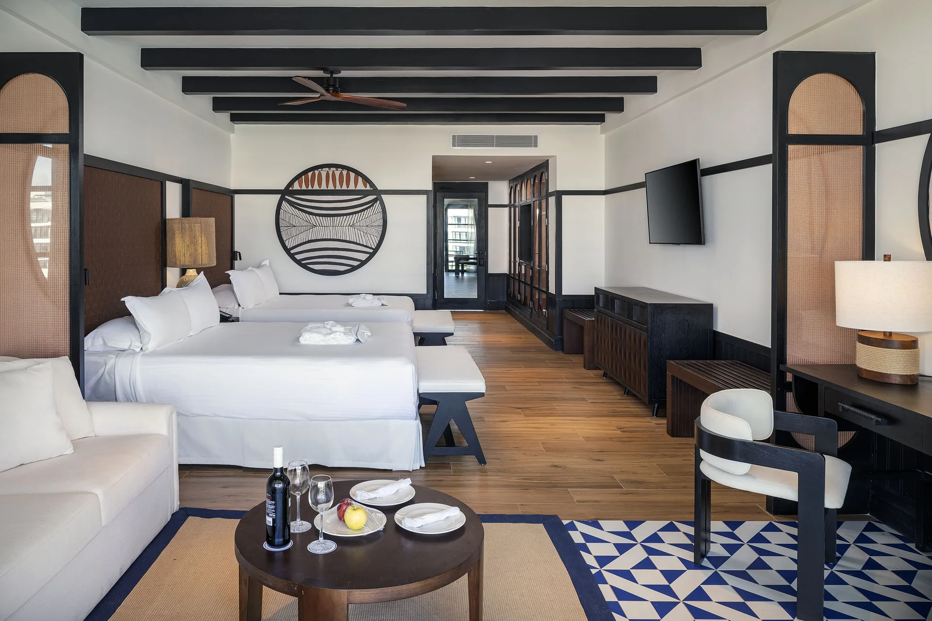 Privilege Junior Suite Swim Up room with two beds, sofa and desk at Ocean Eden Bay.