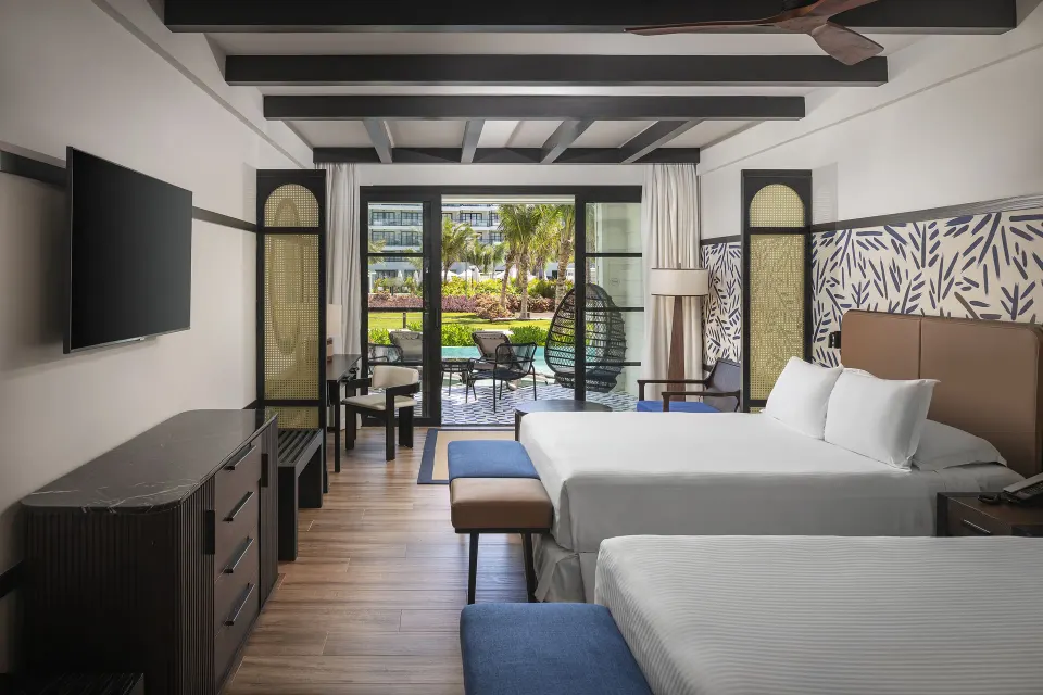 Privilege Junior Suite Swim Up with two beds and patio at Ocean Eden Bay.