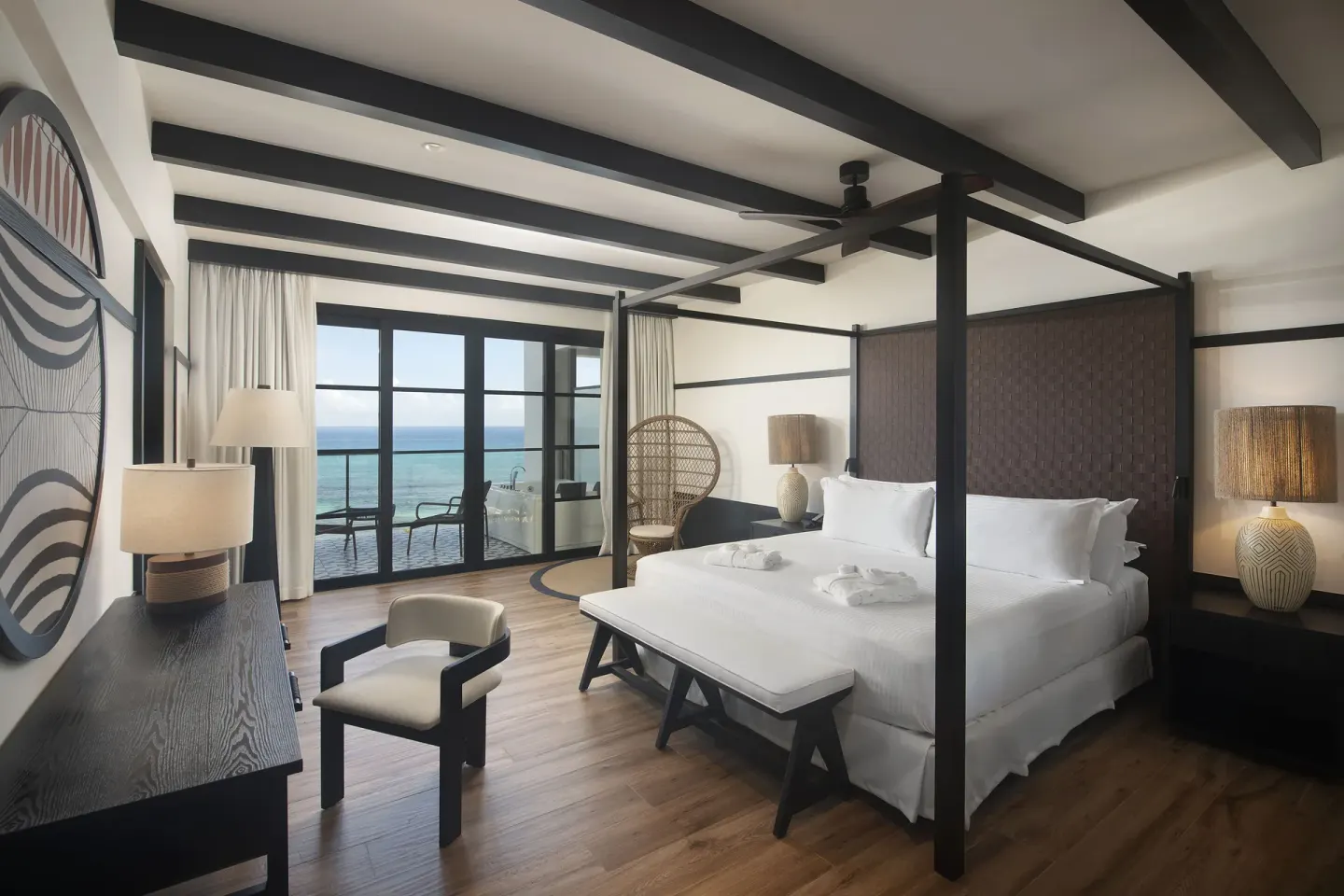 Privilege Master Suite Ocean Eden Bay bedroom with four-poster bed and sea view at Ocean Eden Bay.