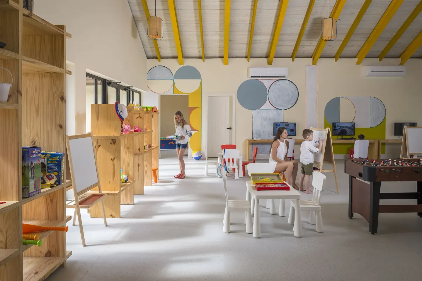 Children's playroom with art easels, tables and foosball at Ocean El Faro Resort.