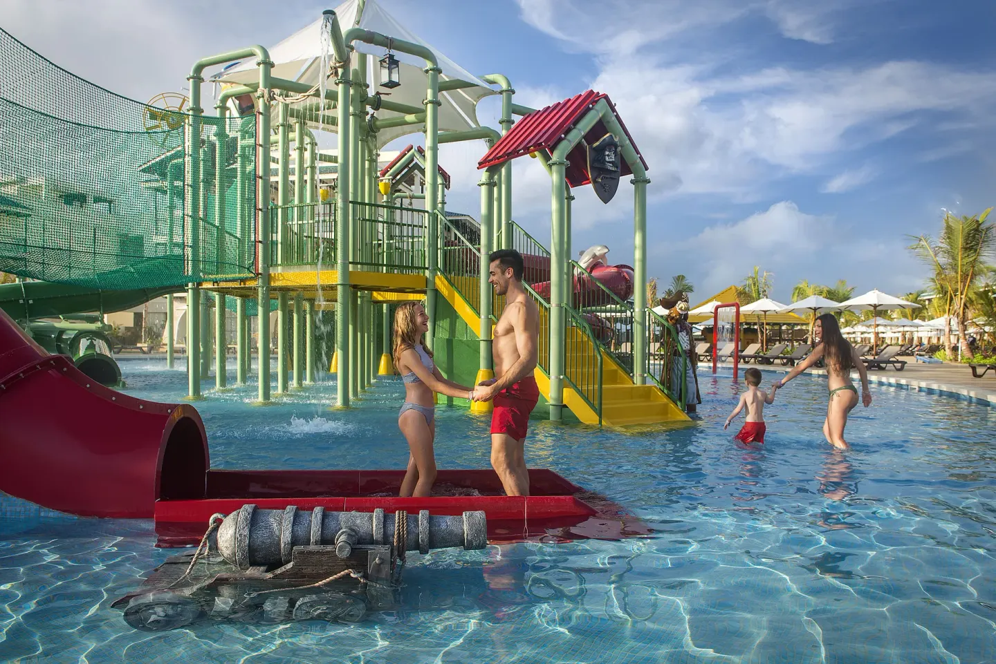Family water play area with slides and shallow pool at Ocean El Faro Resort.