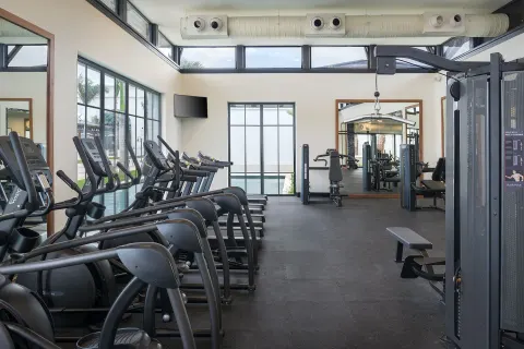 Fitness center with cardio machines and weight equipment at Ocean El Faro Resort.