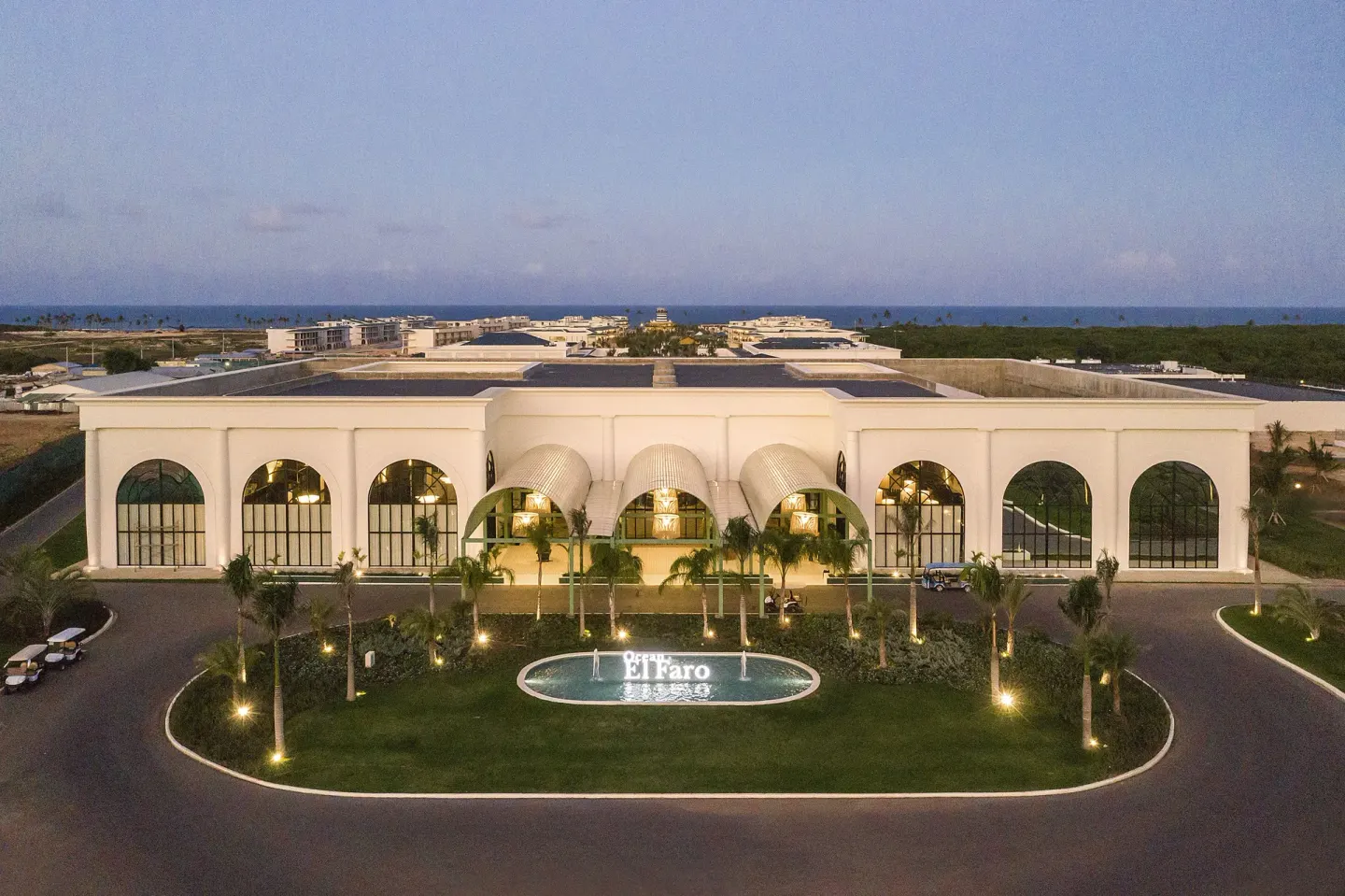 Aerial view of the illuminated entrance building at Ocean El Faro Resort.