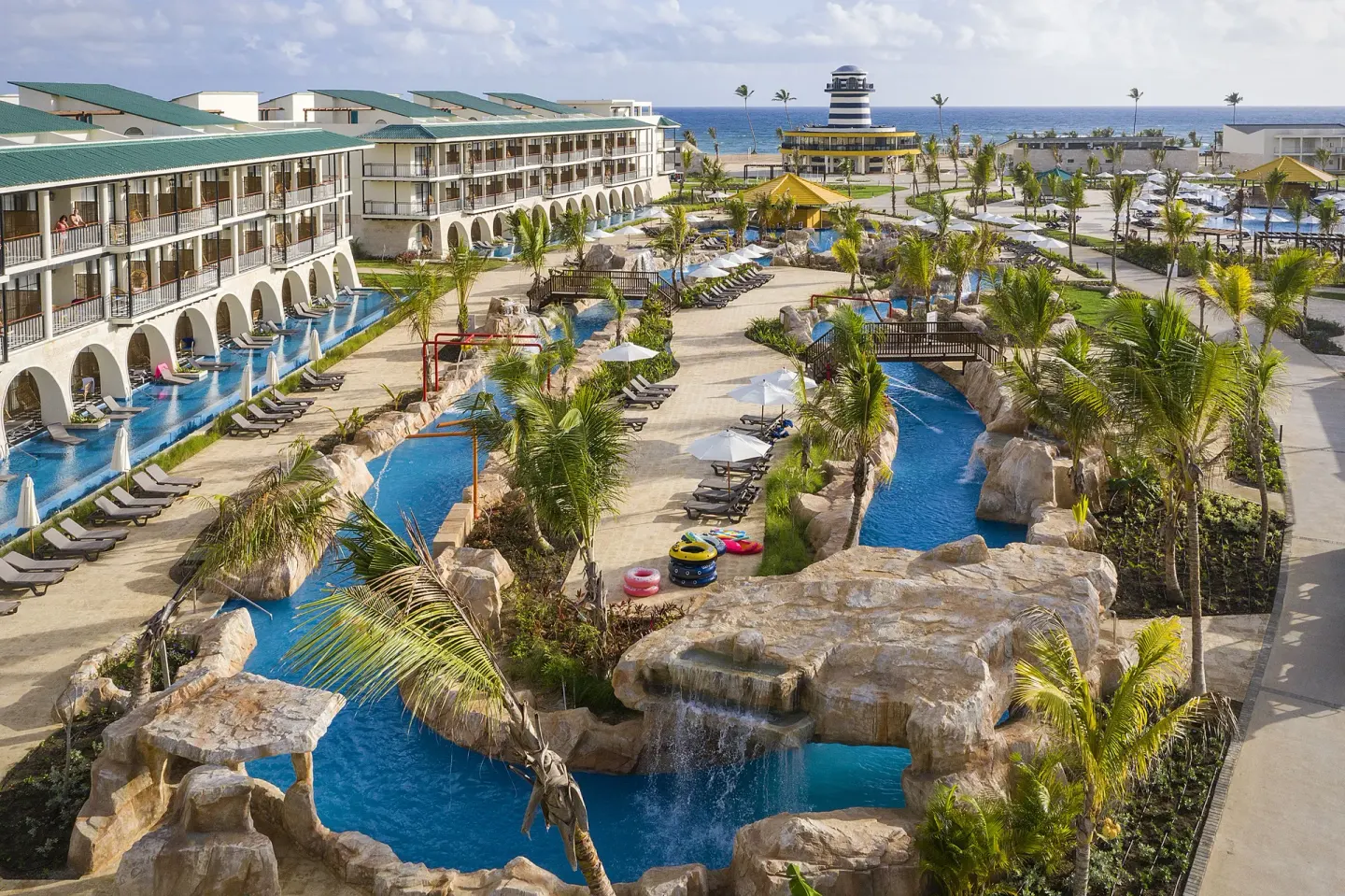 Lazy river, pools, and resort buildings at Ocean El Faro Resort.