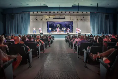 Audience watches dancers on an auditorium stage at Ocean El Faro Resort.