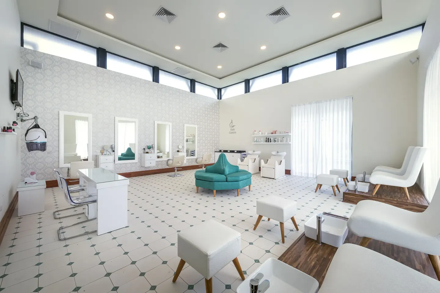 Bright salon and spa room with styling stations and pedicure chairs at Ocean El Faro Resort.