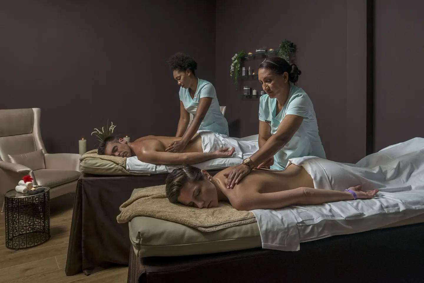 Two guests receiving massages in a spa treatment room at Ocean El Faro Resort.