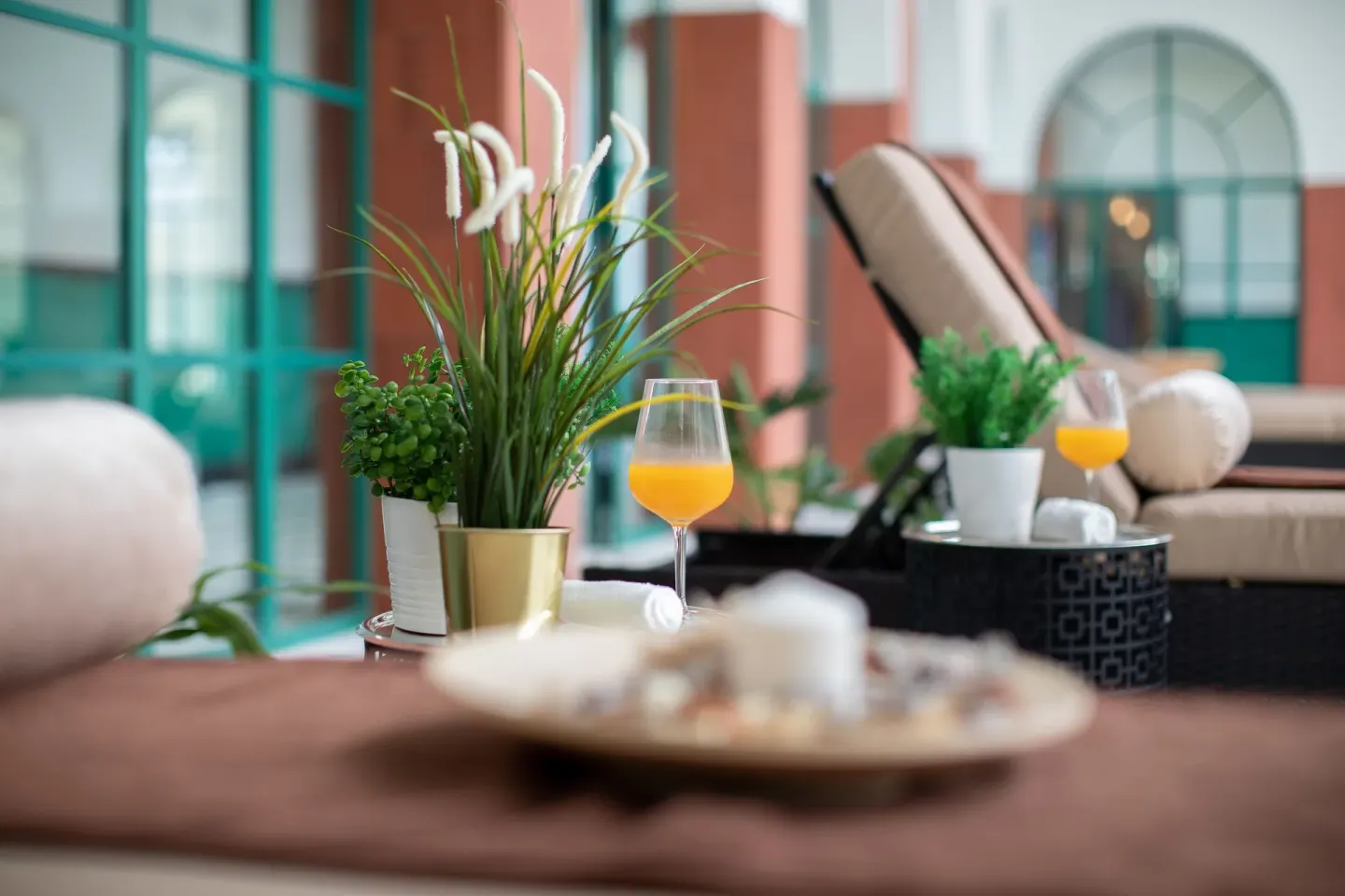Spa lounge detail with plants and orange drinks at Ocean El Faro Resort.