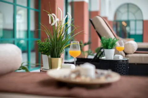 Spa lounge detail with plants and orange drinks at Ocean El Faro Resort.