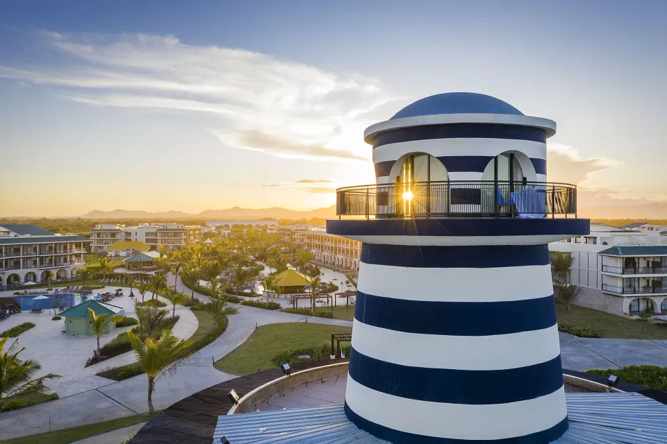 Close view of the striped lighthouse-style tower at sunset at Ocean El Faro Resort.