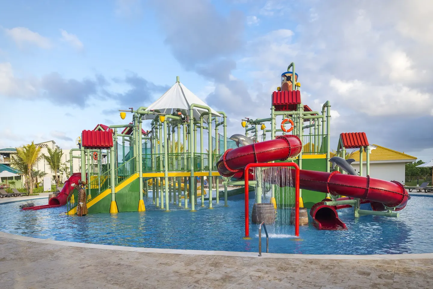 Water park play structure with red slides at Ocean El Faro Resort.