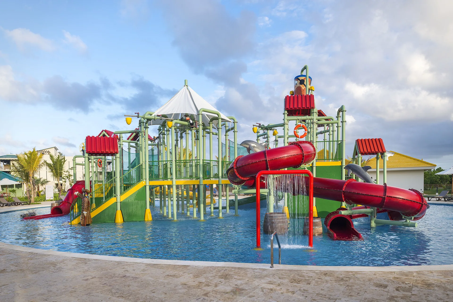 Water park play structure with red slides at Ocean El Faro Resort.