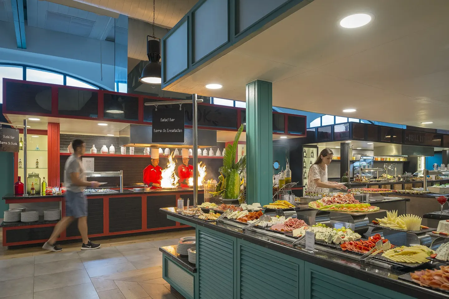 Buffet counters with salad, fruit, and chefs at Ocean El Faro Resort.