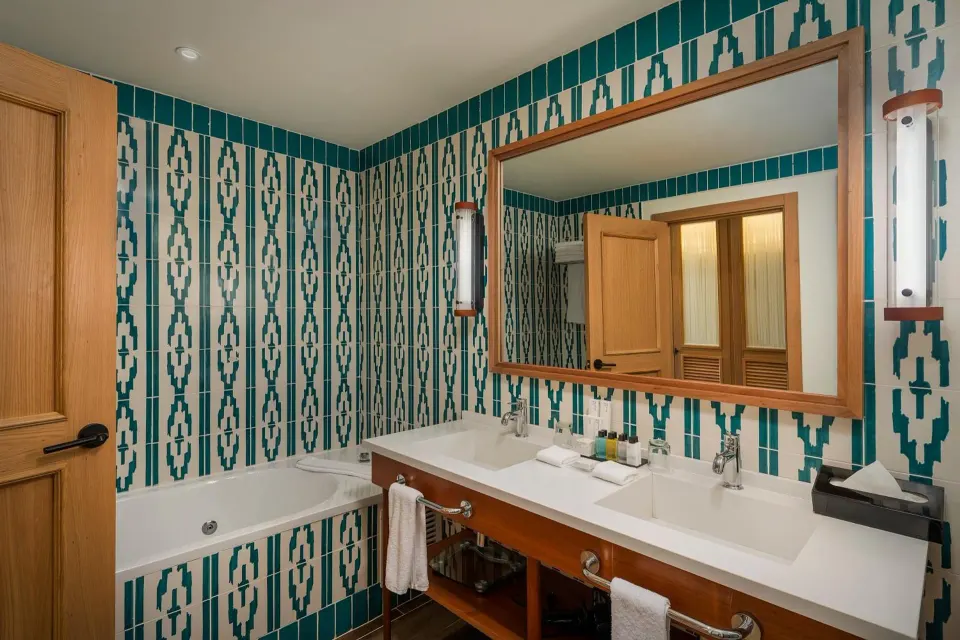 Junior Suite Nature View bathroom at Ocean El Faro Resort with double vanity and bathtub.