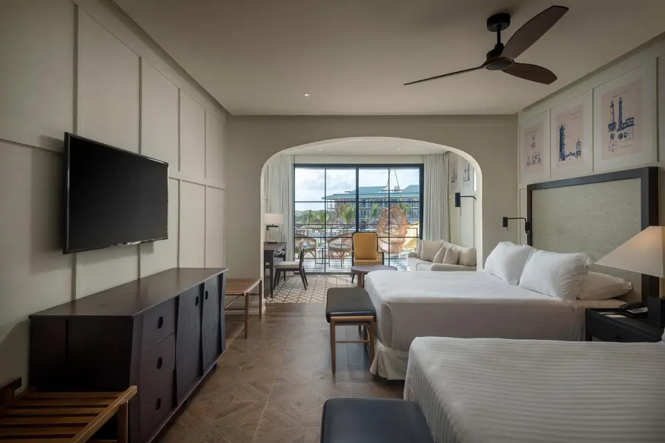 Two-bed Junior Suite Nature View guest room at Ocean El Faro Resort with balcony seating.