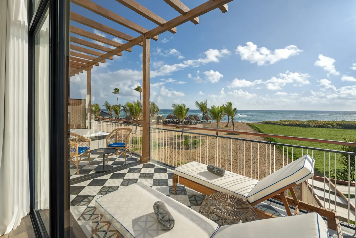 Royal Master Suite Ocean El Faro Resort terrace with loungers and sea view at Ocean El Faro Resort.