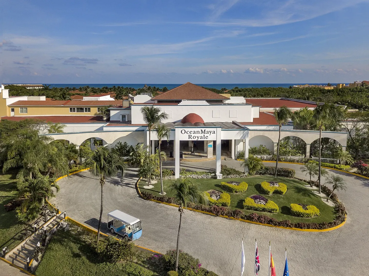 Aerial view of the entrance, gardens, and sea beyond at Ocean Maya Royale.