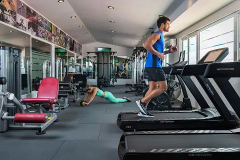Fitness center with treadmills and weight machines at Ocean Maya Royale.