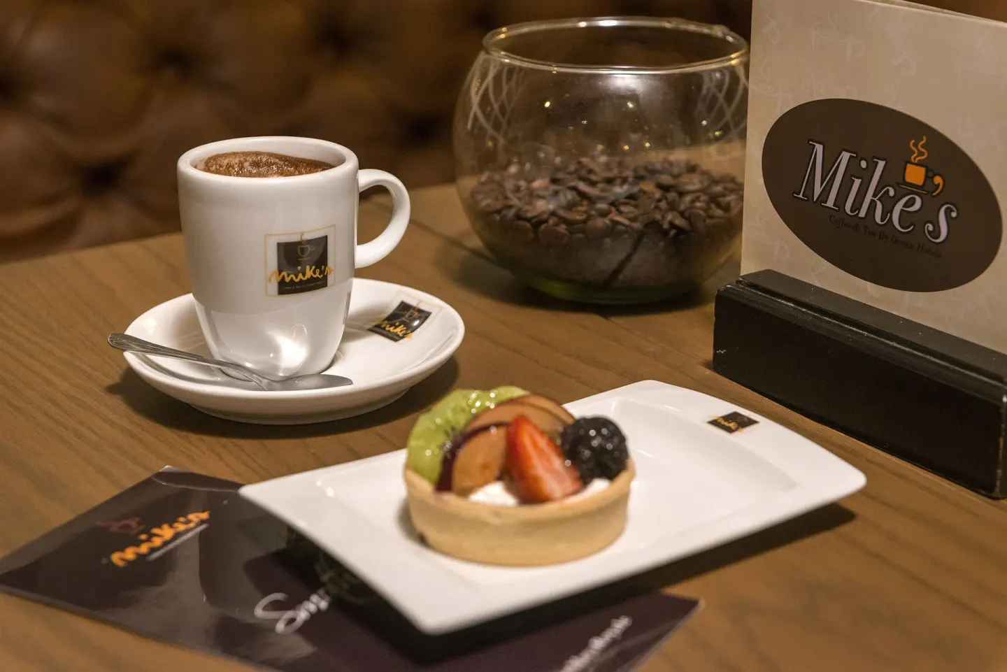 Coffee, fruit tart, coffee beans, and Mike's signage at Ocean Maya Royale.