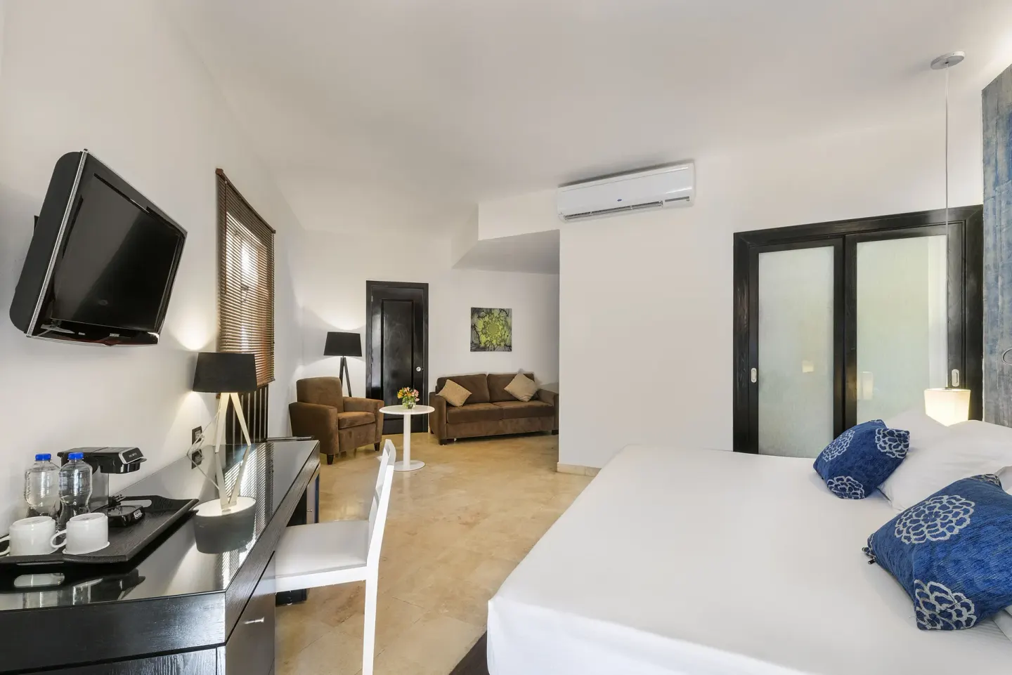 Junior Suite Nature View guest room with bed and sitting area at Ocean Maya Royale.