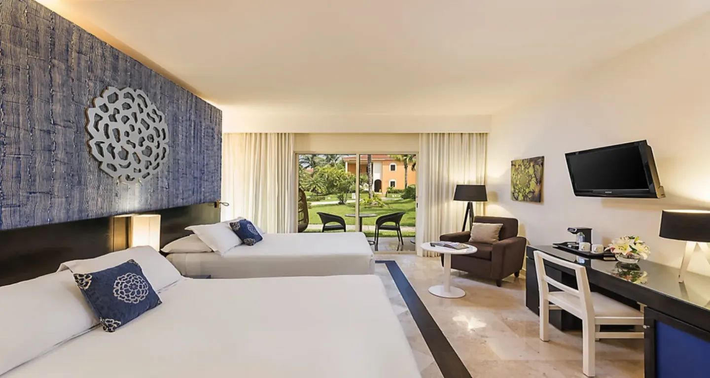 Junior Suite Nature View room with two beds and garden-facing terrace at Ocean Maya Royale.