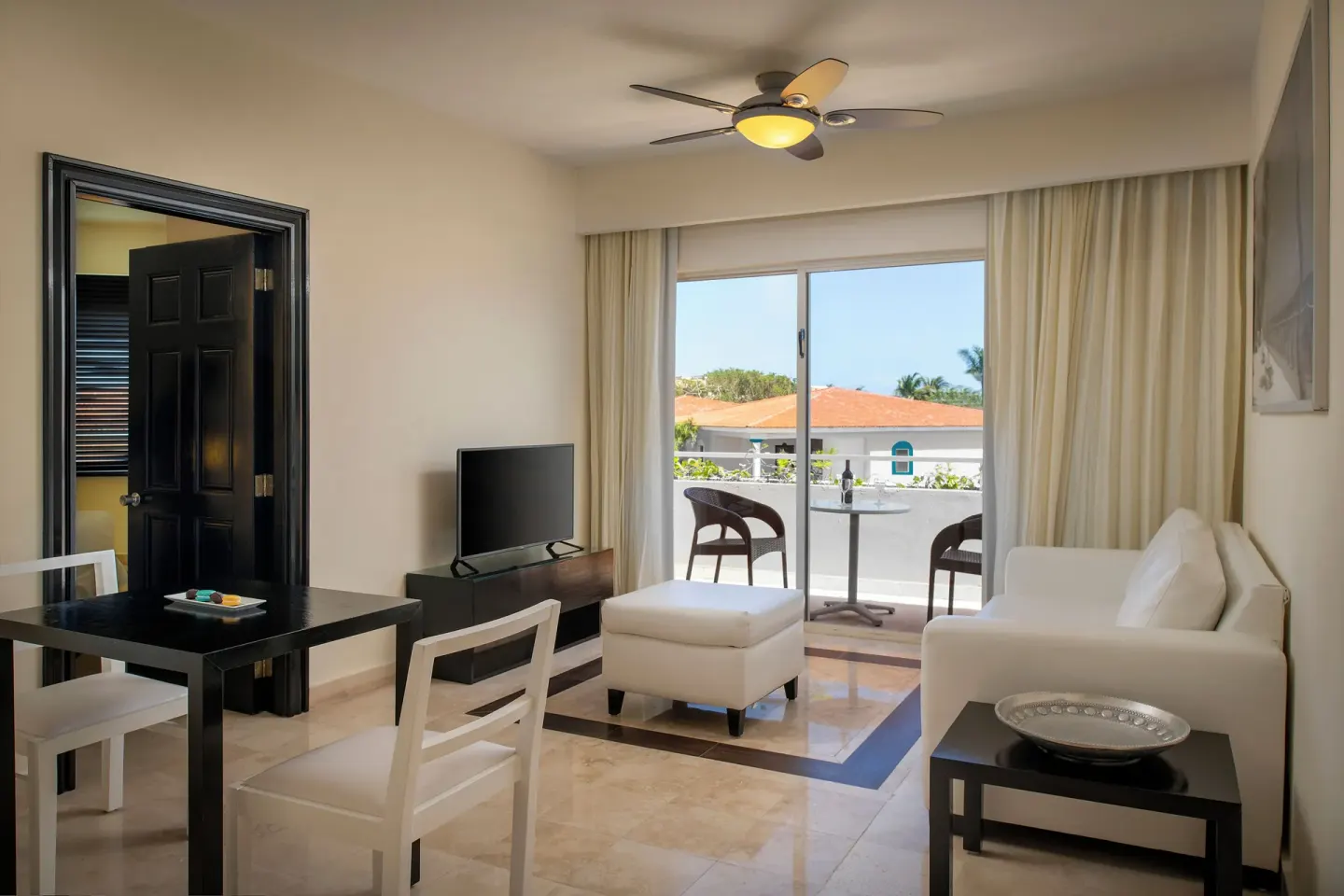 Privilege Romance Suite sitting area with balcony at Ocean Maya Royale.