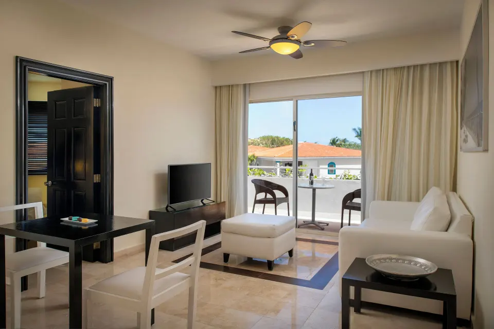Privilege Romance Suite sitting area with balcony at Ocean Maya Royale.