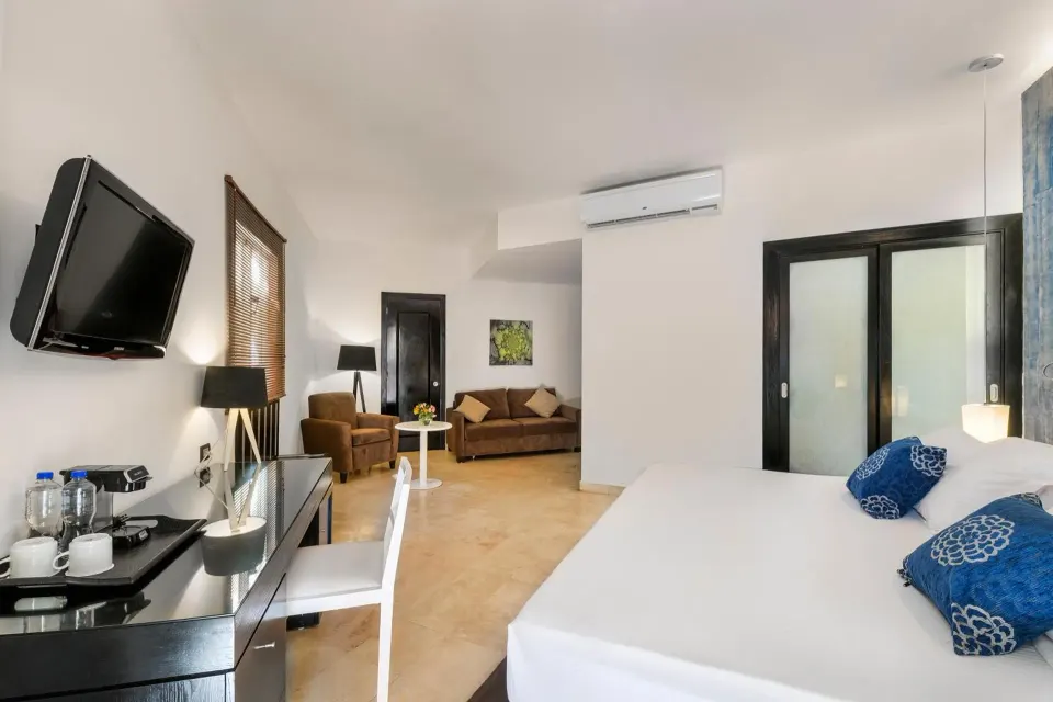Junior suite with king bed and sitting area at Ocean Maya Royale.