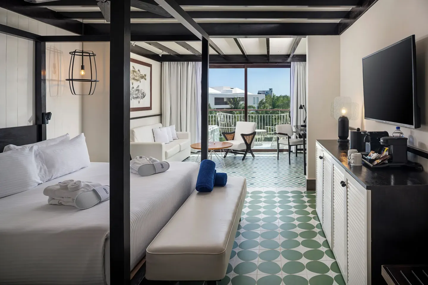 King bed guest room with balcony seating at Ocean Riviera Paradise.
