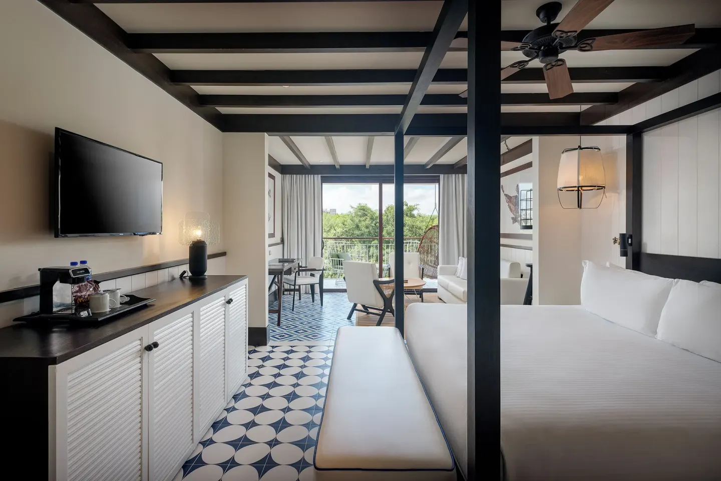 King bed guest room with balcony seating at Ocean Riviera Paradise.