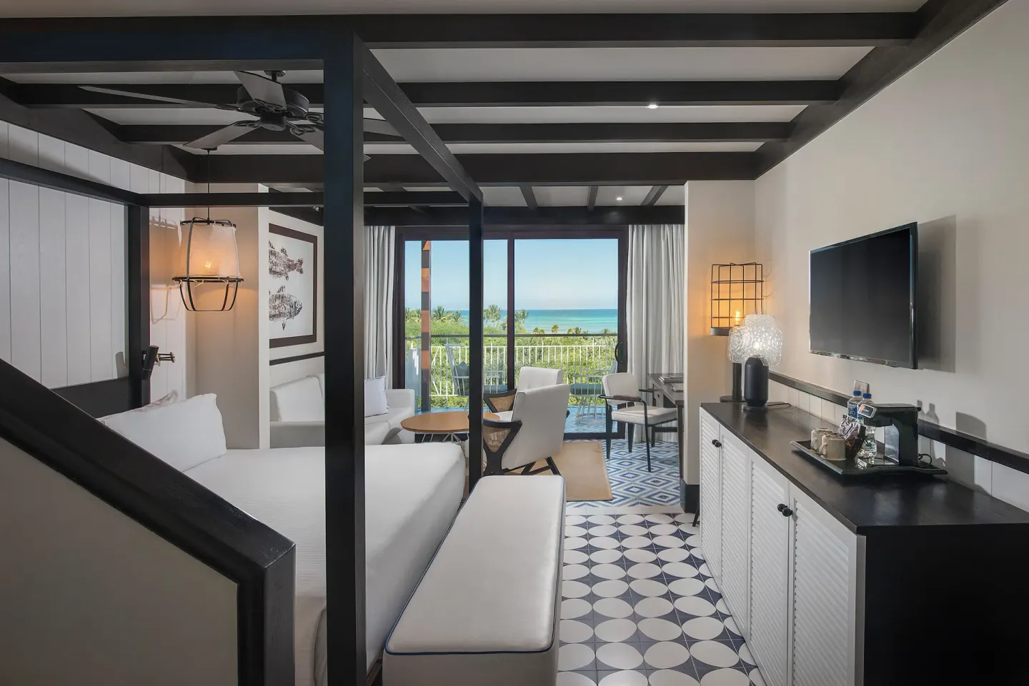 King bed guest room with ocean-view balcony at Ocean Riviera Paradise.