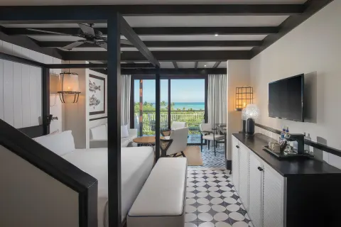 King bed guest room with ocean-view balcony at Ocean Riviera Paradise.
