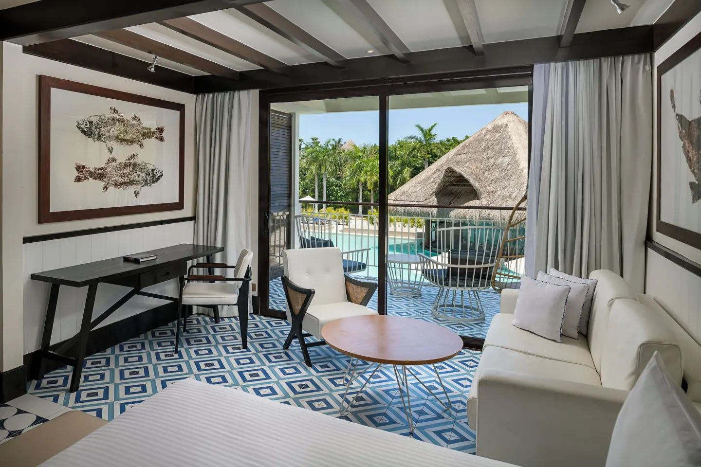 Guest room sitting area with desk, sofa, and balcony at Ocean Riviera Paradise.