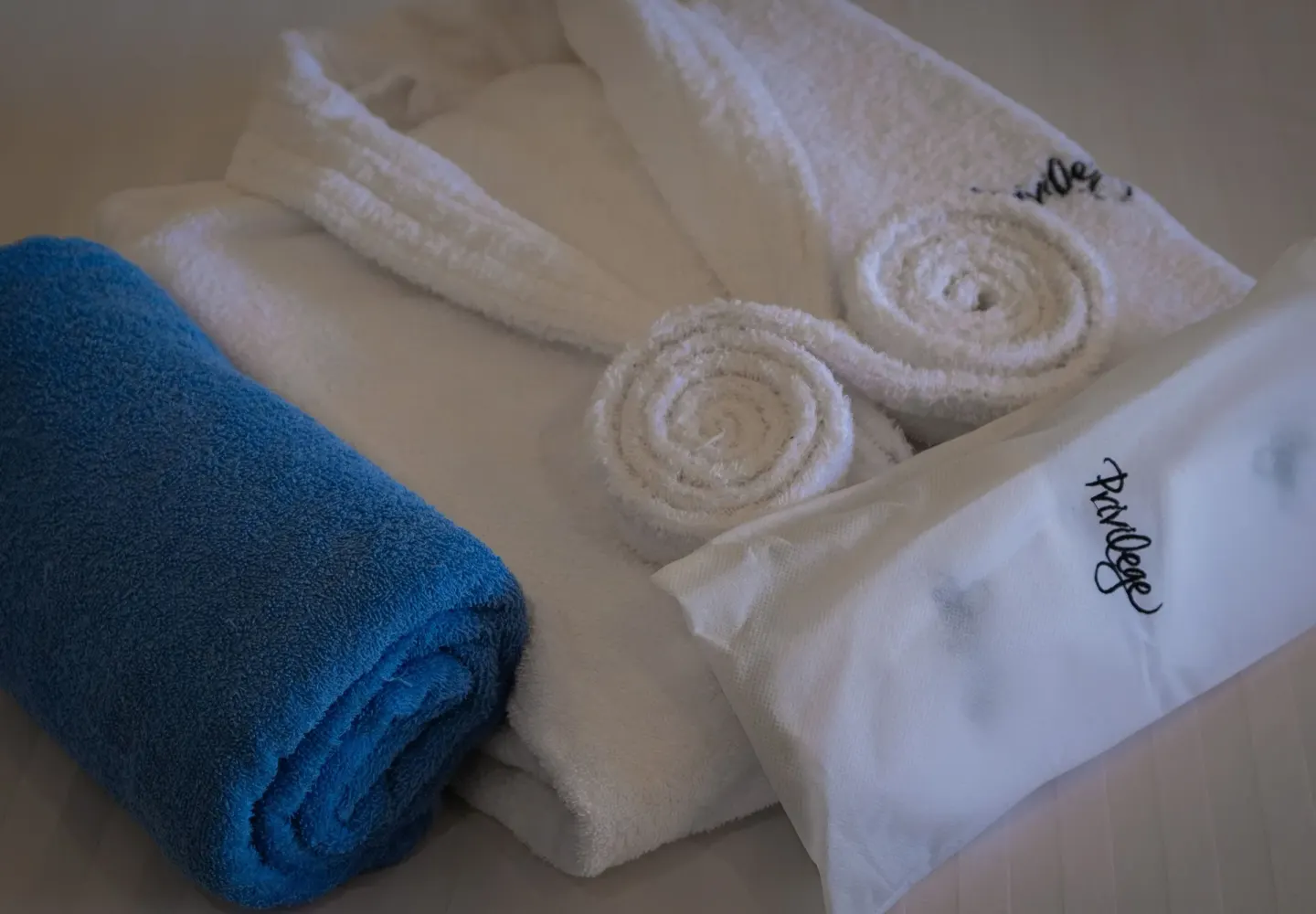 Rolled towels and packaged linens on a bed at Ocean Riviera Paradise.