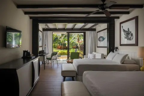 Two-bed guest room with garden-facing patio at Ocean Riviera Paradise.