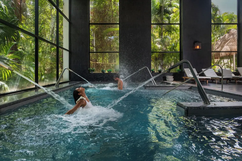 Spa hydrotherapy pool with guests under massage jets at Ocean Riviera Paradise.