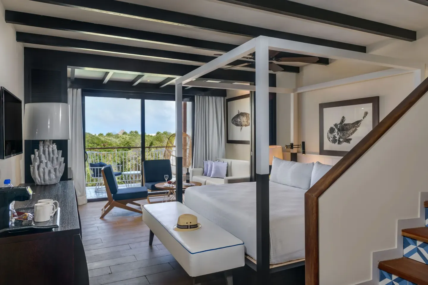 King bed suite with sofa, stairs, and balcony at Ocean Riviera Paradise.