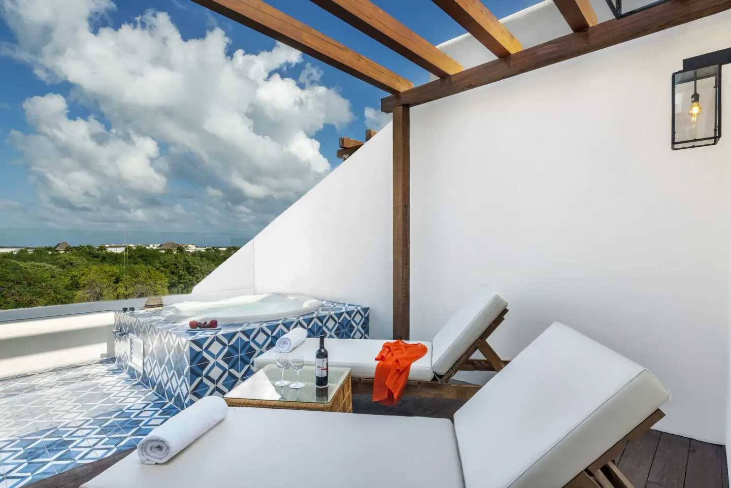 Private terrace with loungers and tiled hot tub at Ocean Riviera Paradise.