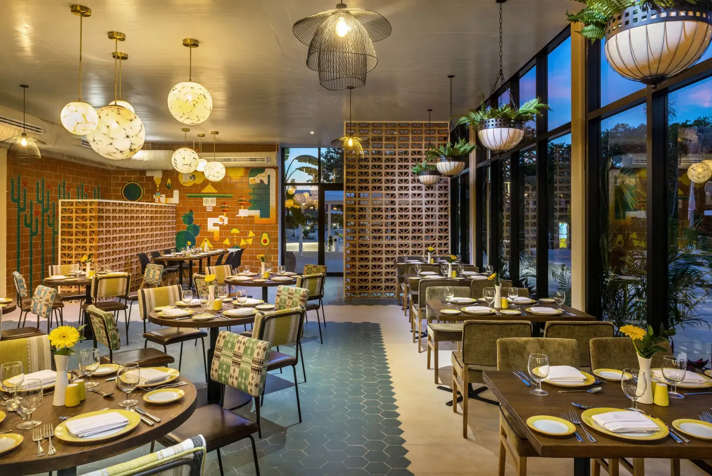 Colorful Mexican-themed dining room with set tables at Ocean Riviera Paradise.