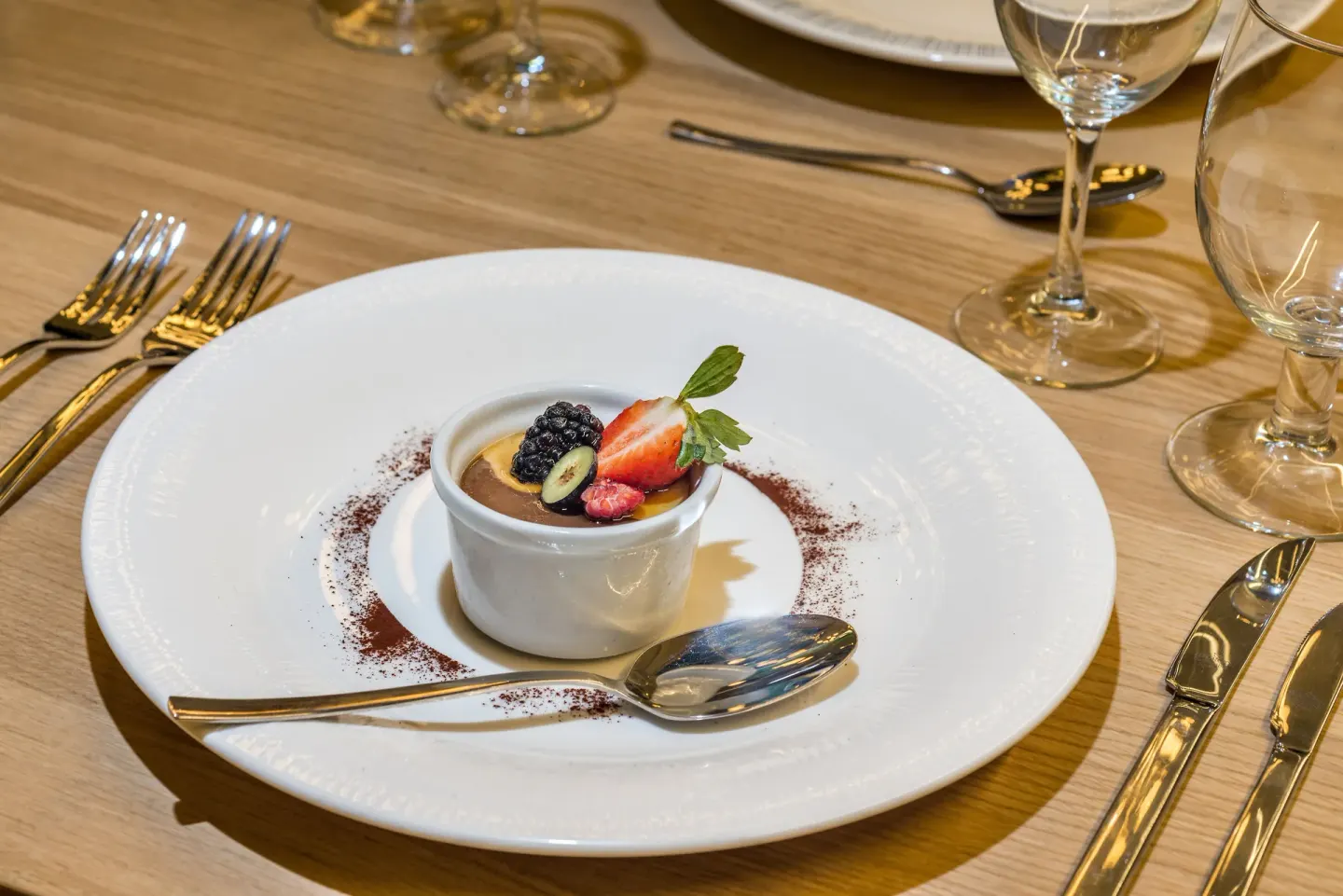 Plated chocolate dessert with berries on a dining table at Ocean Riviera Paradise.