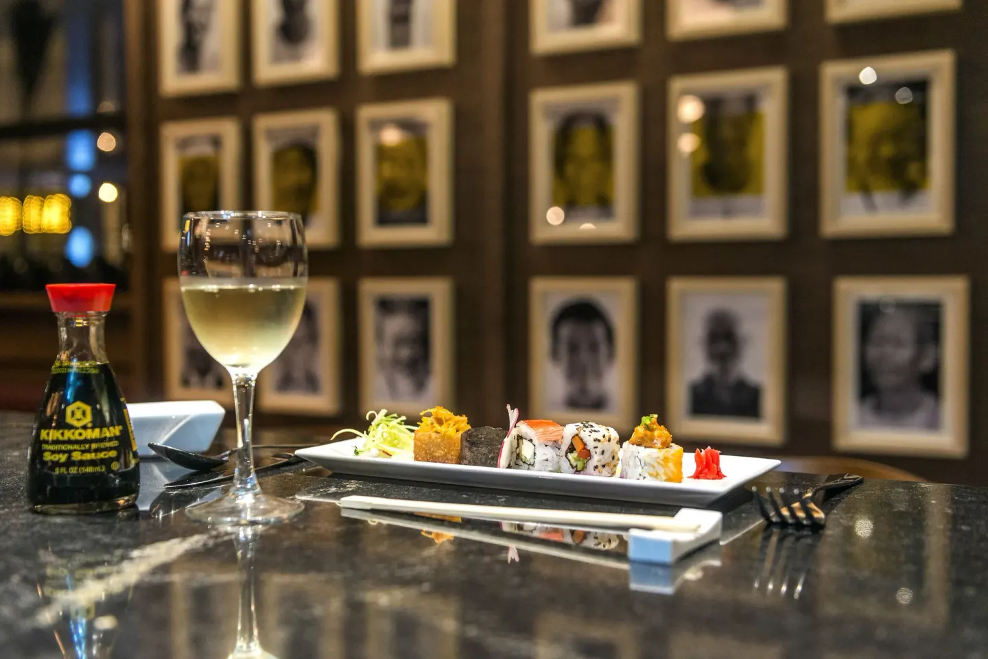 Sushi plate with wine and soy sauce on a counter at Ocean Riviera Paradise.