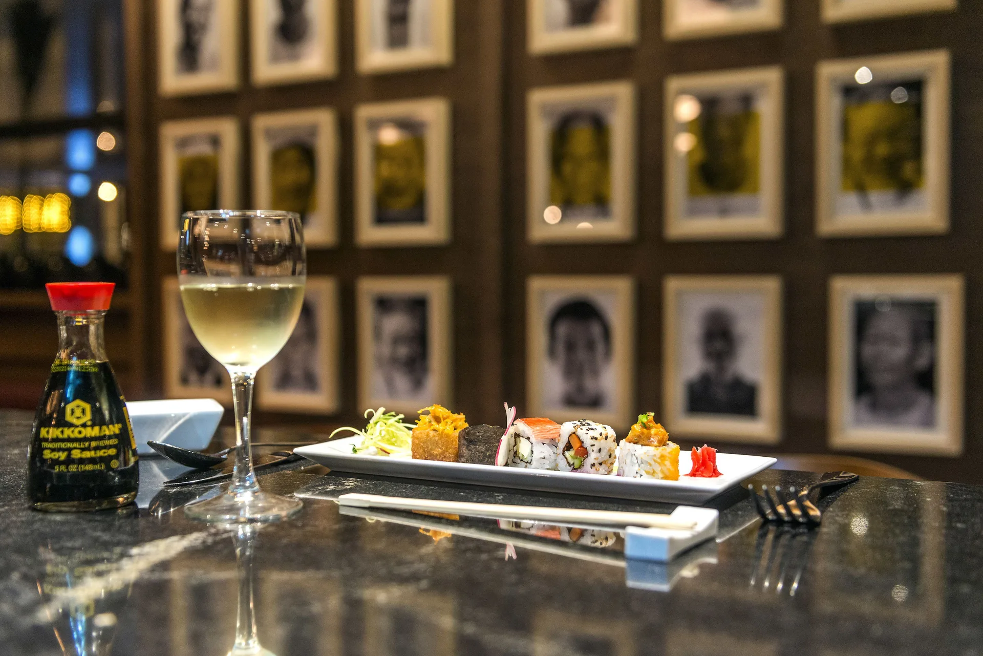 Sushi plate with wine and soy sauce on a counter at Ocean Riviera Paradise.