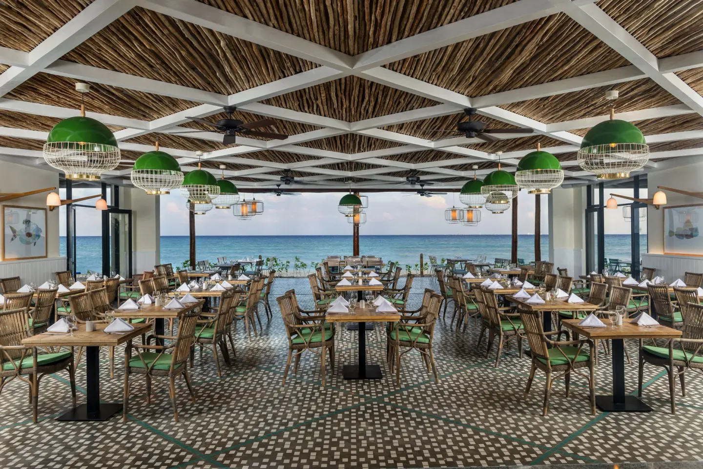 Open-air restaurant dining room facing the sea at Ocean Riviera Paradise.