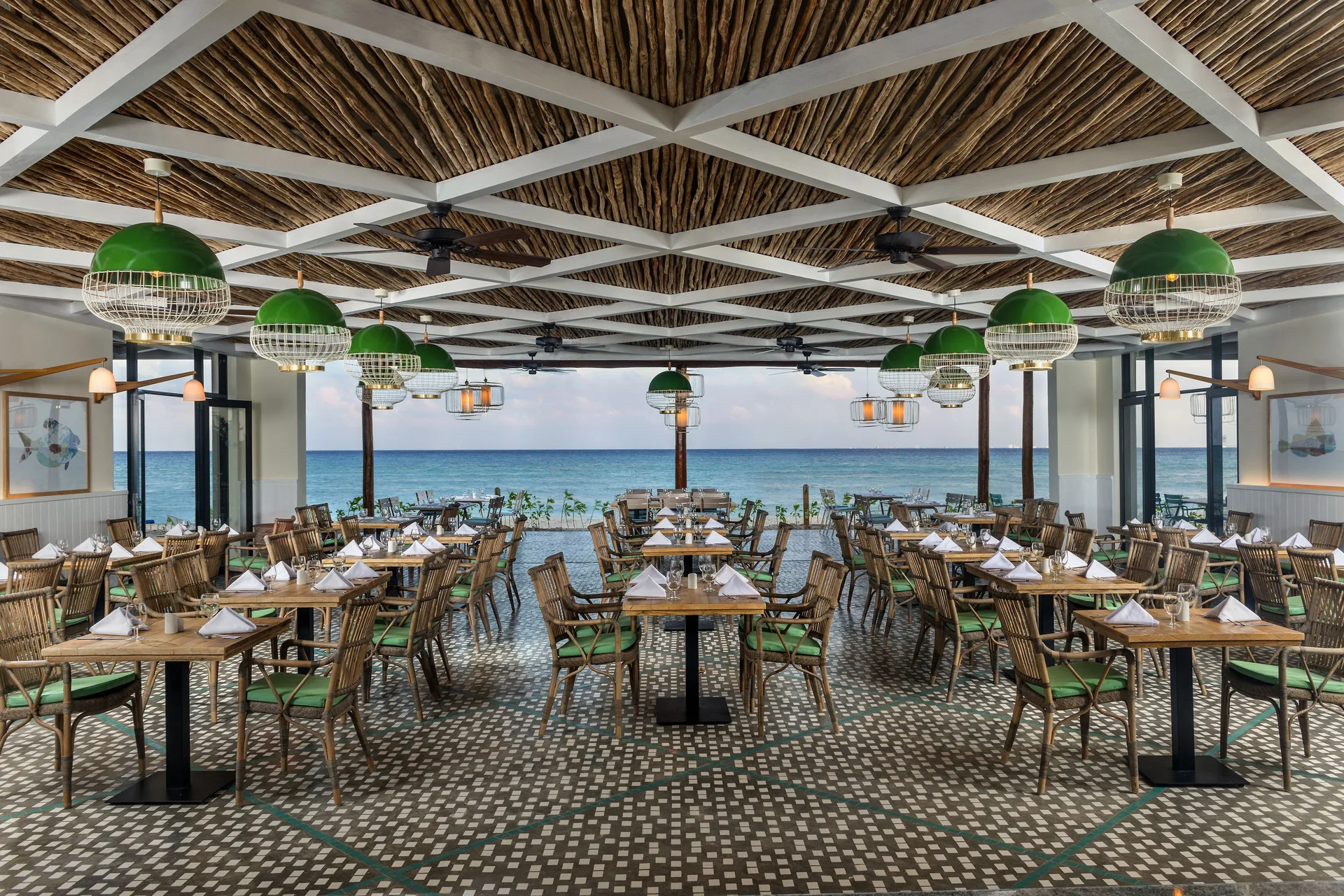 Open-air restaurant dining room facing the sea at Ocean Riviera Paradise.